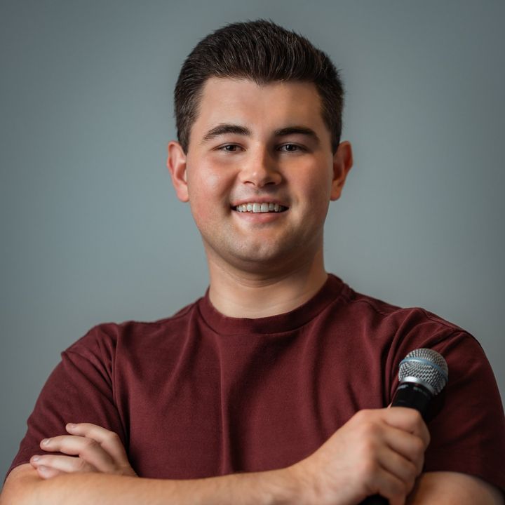 Portrait of Dylan Forge holding a microphone