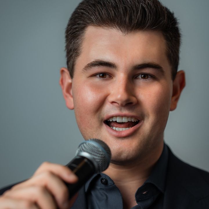 Close-up of Dylan Forge singing into a microphone