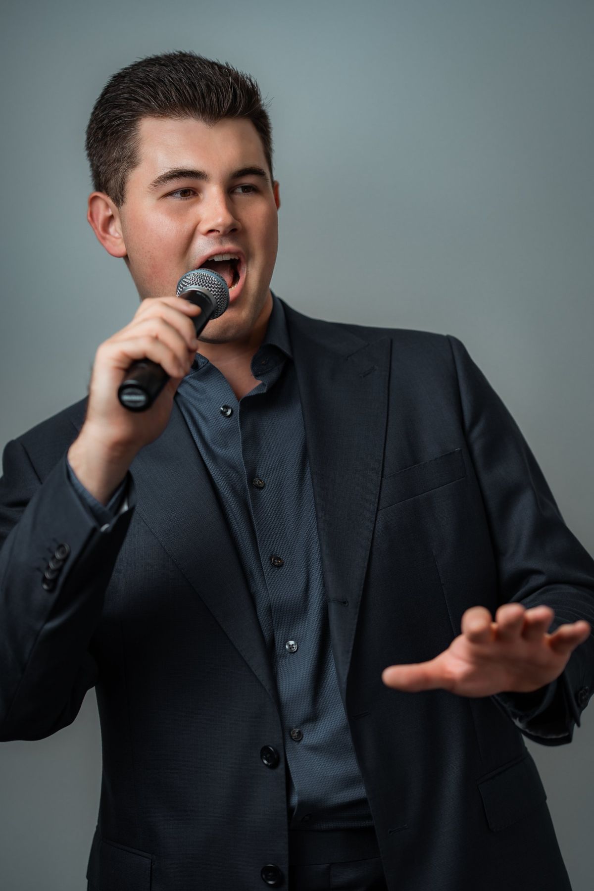 Dylan Forge, Melbourne vocalist, singing into a microphone
